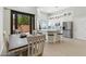 Well-lit kitchen features an island with seating, stainless steel appliances, and an adjacent dining area with outdoor access at 8785 E Greenview Dr, Gold Canyon, AZ 85118