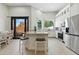 Spacious kitchen with white cabinetry, a breakfast bar, modern appliances, and easy access to the outdoor living space at 8785 E Greenview Dr, Gold Canyon, AZ 85118