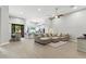 Open-concept living room features a large sectional sofa, wood-look tile floors, and flows seamlessly into the kitchen at 8785 E Greenview Dr, Gold Canyon, AZ 85118