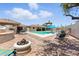 Resort-style pool area features a covered gazebo, lounge chairs, desert landscaping, and outdoor kitchen at 8785 E Greenview Dr, Gold Canyon, AZ 85118