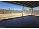 Backyard featuring a covered patio and a block fence for privacy, with room for landscaping and recreation at 8936 W Mackenzie Dr, Phoenix, AZ 85037