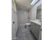 Modern bathroom with tiled shower, sleek vanity, and contemporary fixtures at 8936 W Mackenzie Dr, Phoenix, AZ 85037
