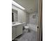 Well-lit bathroom with vanity and tiled tub at 8936 W Mackenzie Dr, Phoenix, AZ 85037