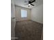 Comfortable carpeted bedroom with a ceiling fan and a bright window at 8936 W Mackenzie Dr, Phoenix, AZ 85037