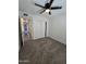 Neat carpeted bedroom with closet and fan at 8936 W Mackenzie Dr, Phoenix, AZ 85037