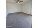 Comfortable carpeted bedroom with ceiling fan and ample closet space at 8936 W Mackenzie Dr, Phoenix, AZ 85037