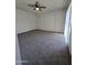 Spacious carpeted bedroom featuring dual closets and a ceiling fan for comfort at 8936 W Mackenzie Dr, Phoenix, AZ 85037