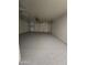 Spacious garage with a sealed floor and an automatic door provides secure parking and ample storage space at 8936 W Mackenzie Dr, Phoenix, AZ 85037