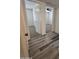 Inviting hallway featuring modern flooring, providing access to bedrooms at 8936 W Mackenzie Dr, Phoenix, AZ 85037