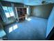 Bedroom featuring carpeted flooring, wood paneling, desk, and natural light at 9501 E Broadway Rd # 68, Mesa, AZ 85208