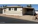 Tan home in a landscaped community with a covered parking area, desert landscaping and a low-maintenance yard at 9501 E Broadway Rd # 68, Mesa, AZ 85208