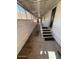 Hallway with steps leading to a carpeted walkway with covered ceiling and partial walls at 9501 E Broadway Rd # 68, Mesa, AZ 85208