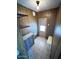 Hallway with a light fixture, wood paneling, tile flooring and shelving at 9501 E Broadway Rd # 68, Mesa, AZ 85208