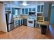 Kitchen features wood cabinets, stainless-steel appliances, and hardwood floors at 9501 E Broadway Rd # 68, Mesa, AZ 85208