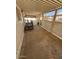Spacious patio featuring a concrete slab, metal awning, and security gate at 9501 E Broadway Rd # 68, Mesa, AZ 85208