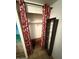 Shower stall area featuring red curtains, built-in shelving, and tiled floors at 9501 E Broadway Rd # 68, Mesa, AZ 85208
