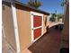 This is a cozy storage shed with a red door and a concrete base at 9501 E Broadway Rd # 68, Mesa, AZ 85208