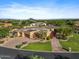 Immaculate home with desert landscaping and a circular driveway, with a basketball court and solar panels at 9693 N 129Th Pl, Scottsdale, AZ 85259