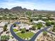 Breathtaking aerial image of the community with desert landscaping, mountain views, and winding roads at 9693 N 129Th Pl, Scottsdale, AZ 85259