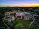 Aerial view of home with pool and mountain views at sunset at 9693 N 129Th Pl, Scottsdale, AZ 85259