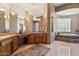 Spacious bathroom with a vanity area, soaking tub and glass block window feature at 9693 N 129Th Pl, Scottsdale, AZ 85259