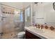 Well-maintained bathroom with a tiled shower, travertine countertop and wood cabinets at 9693 N 129Th Pl, Scottsdale, AZ 85259