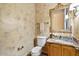 Elegant bathroom featuring marble countertops and an ornate gold-framed mirror at 9693 N 129Th Pl, Scottsdale, AZ 85259