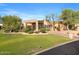 Beautiful home with well-manicured lawn, mature trees, and a circular driveway in a serene setting at 9693 N 129Th Pl, Scottsdale, AZ 85259