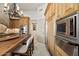 Bright kitchen featuring stainless steel appliances, wood cabinets, kitchen island and chandelier lighting at 9693 N 129Th Pl, Scottsdale, AZ 85259