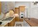 Well-lit kitchen with a gas range, granite countertops, stainless steel appliances, and a kitchen island at 9693 N 129Th Pl, Scottsdale, AZ 85259