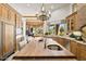Open kitchen with wood cabinets, granite countertops, and an island with a sink and seating at 9693 N 129Th Pl, Scottsdale, AZ 85259