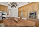 Spacious kitchen with stainless steel appliances, wood cabinets and a large island with seating at 9693 N 129Th Pl, Scottsdale, AZ 85259