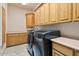 Functional laundry room with ample cabinet space and modern washer and dryer at 9693 N 129Th Pl, Scottsdale, AZ 85259
