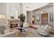 Cozy living room showcasing a fireplace with stone surround, plush seating and high ceilings at 9693 N 129Th Pl, Scottsdale, AZ 85259