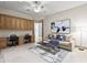 Inviting living room with travertine floors, built-ins, and a large abstract art piece over a comfortable sofa at 9693 N 129Th Pl, Scottsdale, AZ 85259