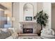 Cozy living room with a stone fireplace, comfortable seating, and elegant finishes at 9693 N 129Th Pl, Scottsdale, AZ 85259