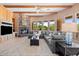Comfortable living room with fireplace, windows overlooking green yard, and convenient access to the kitchen at 9693 N 129Th Pl, Scottsdale, AZ 85259