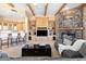 Open concept living room featuring wooden beams, built-ins, and stone fireplace at 9693 N 129Th Pl, Scottsdale, AZ 85259