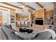 Spacious living room featuring wood beam ceilings, large windows, custom cabinets, and a comfortable gray sofa at 9693 N 129Th Pl, Scottsdale, AZ 85259