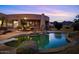 Backyard pool with diving board and mountain views at twilight at 9693 N 129Th Pl, Scottsdale, AZ 85259