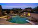 Backyard pool with diving board and mountain views at twilight at 9693 N 129Th Pl, Scottsdale, AZ 85259