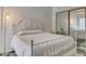 Bedroom featuring white metal bed frame, natural lighting and closet with mirror doors at 101 N 7Th St # 225, Phoenix, AZ 85034
