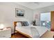Cozy bedroom with wood-frame bed, stylish decor, and ample natural light at 101 N 7Th St # 225, Phoenix, AZ 85034