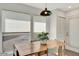 Bright dining room featuring wood table, overhead lighting, and large windows at 101 N 7Th St # 225, Phoenix, AZ 85034