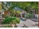 Community hot tub with mature trees, privacy fence, and lounge chairs at 101 N 7Th St # 225, Phoenix, AZ 85034