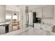 Bright kitchen with stainless steel appliances, white cabinets, and marbled countertops at 101 N 7Th St # 225, Phoenix, AZ 85034