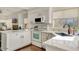 Bright kitchen featuring white cabinets, marble countertops, and stainless steel sink fixtures at 101 N 7Th St # 225, Phoenix, AZ 85034