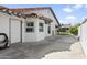 This backyard shows a detached garage, a concrete patio, and mature landscaping at 1015 E Paradise Ln, Phoenix, AZ 85022