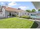 This backyard features a pool, grassy area, patio, and charming block fencing at 1015 E Paradise Ln, Phoenix, AZ 85022