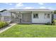This backyard features a covered patio, outdoor grill, and well-manicured lawn at 1015 E Paradise Ln, Phoenix, AZ 85022